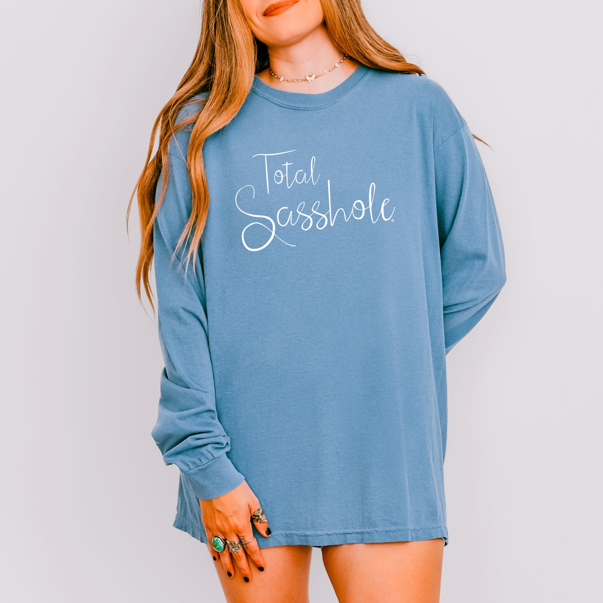 Women wearing a blue long-sleeve shirt with 'Total Sasshole' text on a plain background