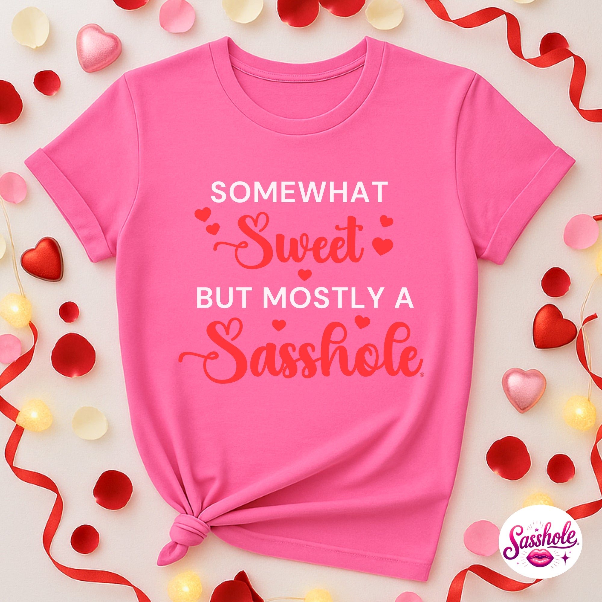 Image of Pink t-shirt with humorous text surrounded by decorative elements on a light background