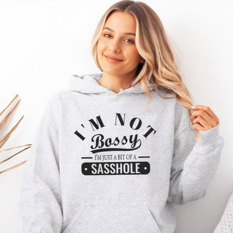 Person wearing a gray hoodie with text design on a white background