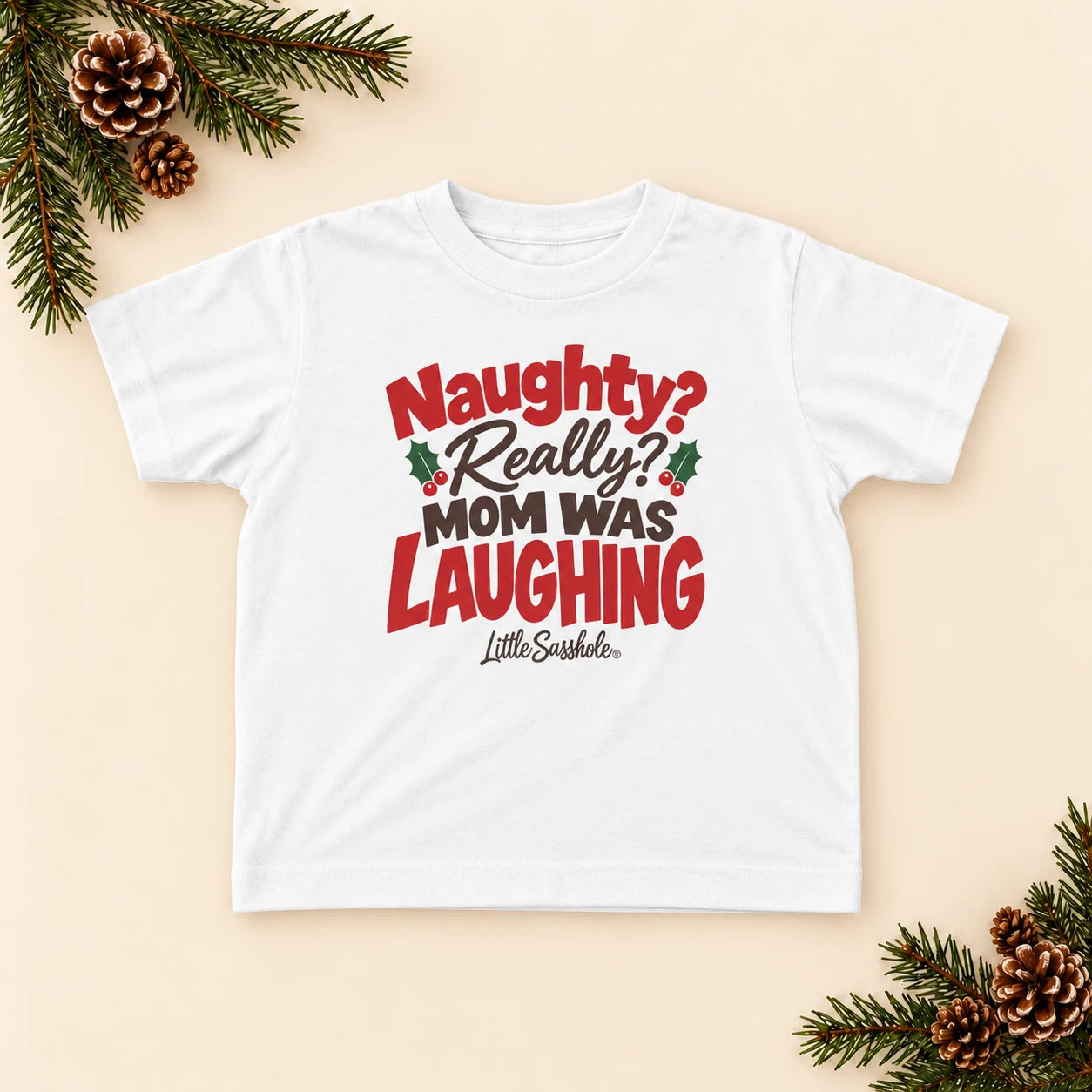 Image of Naughty? Really? Mom Was Laughing — Toddler Graphic Tee — festive product flat lay