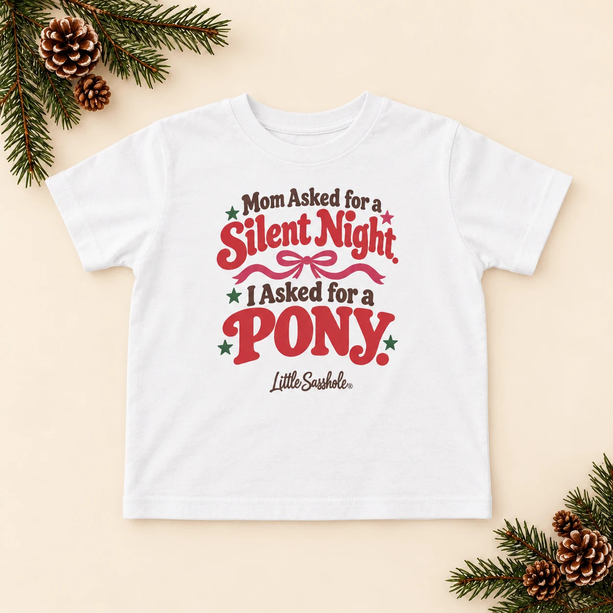 Image of Mom Asked for a Silent Night. I Asked for a Pony. — Toddler Graphic Tee — festive product flat lay