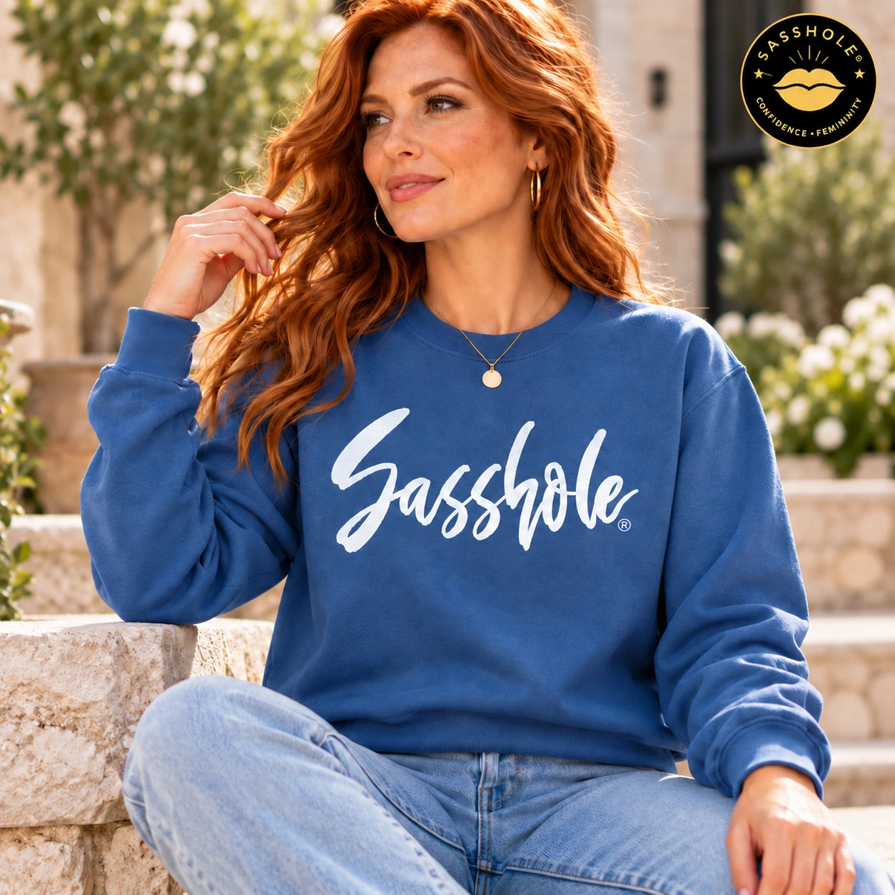 Image of Woman wearing the Indigo Blue Signature Script Sasshole Gildan 18000 crewneck sweatshirt outdoors.