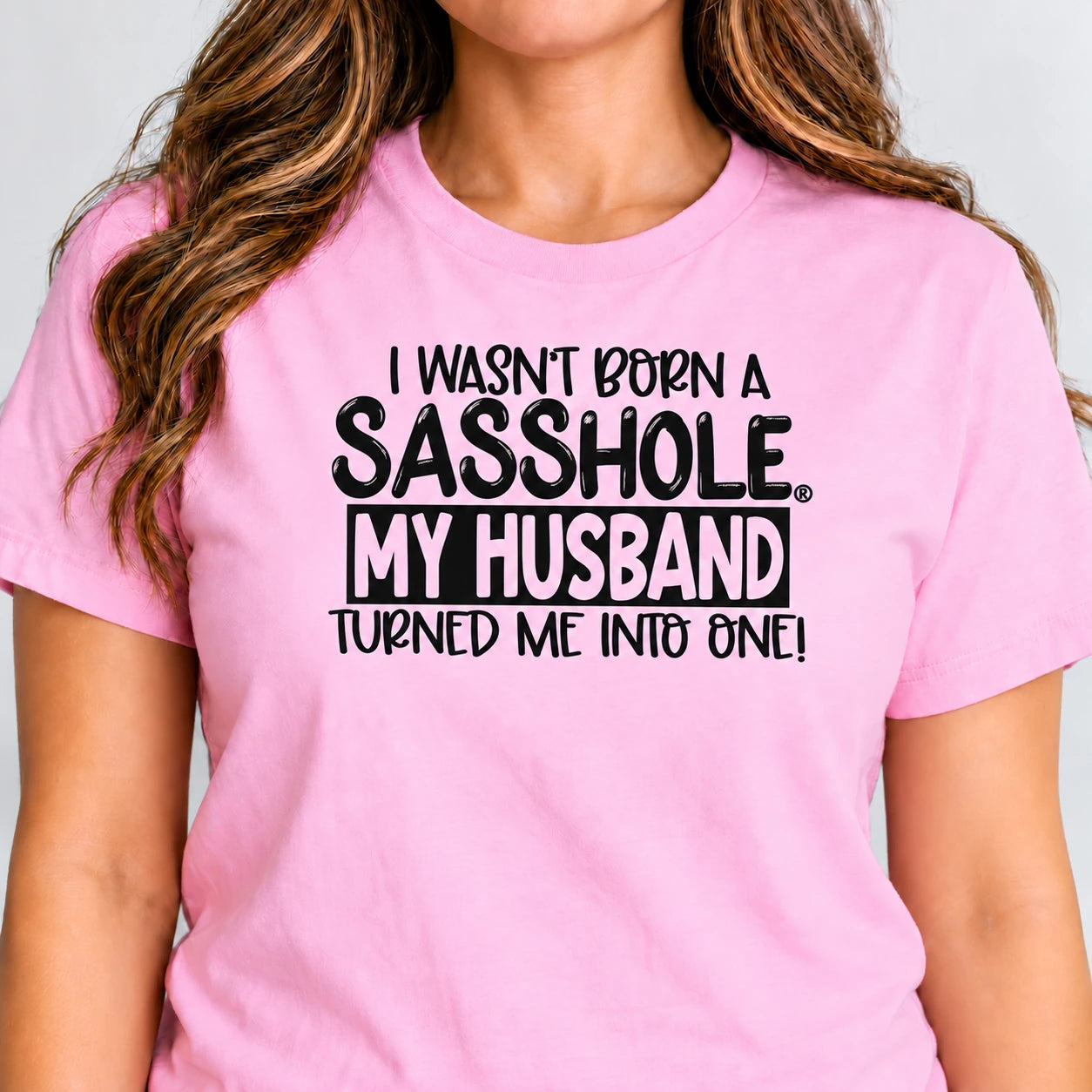 Image of I Wasn’t Born a Sasshole, My Husband Turned Me Into One! print close-up on Pink jersey.